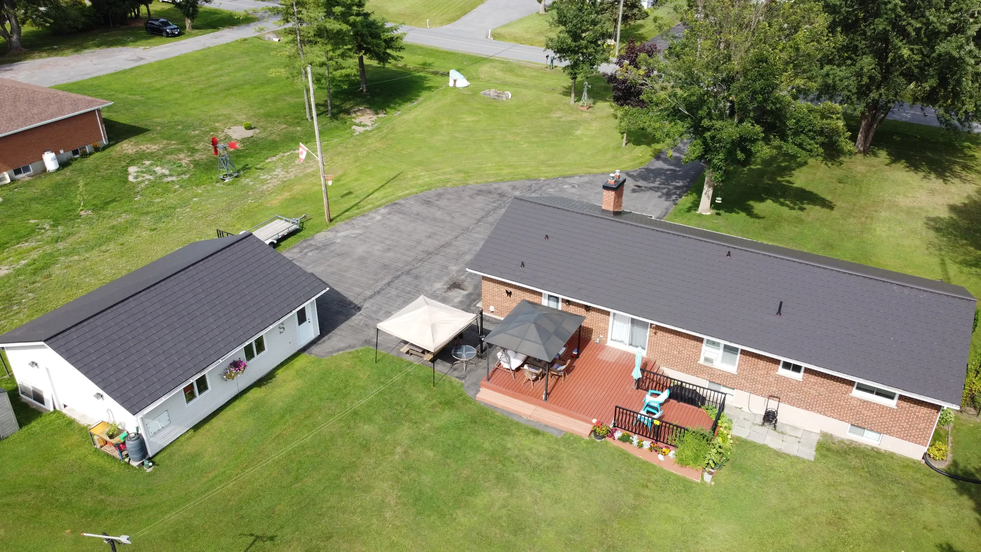 Wakefield Bridge metal shingles installed on a home and detached garage
