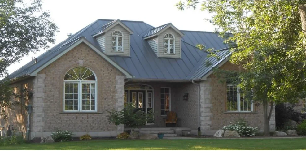 Dark Heritage Junior panels installed around a stone-clad home